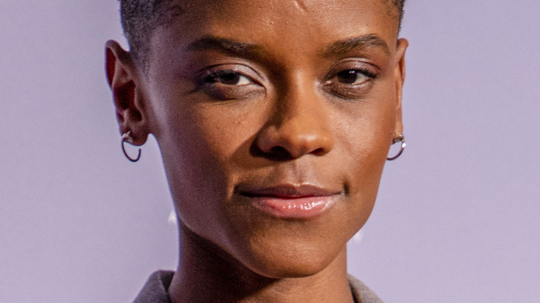 Letitia Wright stares ahead in earrings 