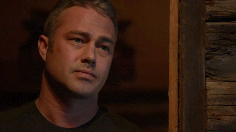 Kelly Severide leaning against wall