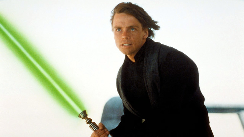 Luke Skywalker wields a lightsaber