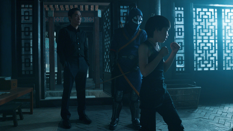 Tony Leung looks over young Shang-Chi's training