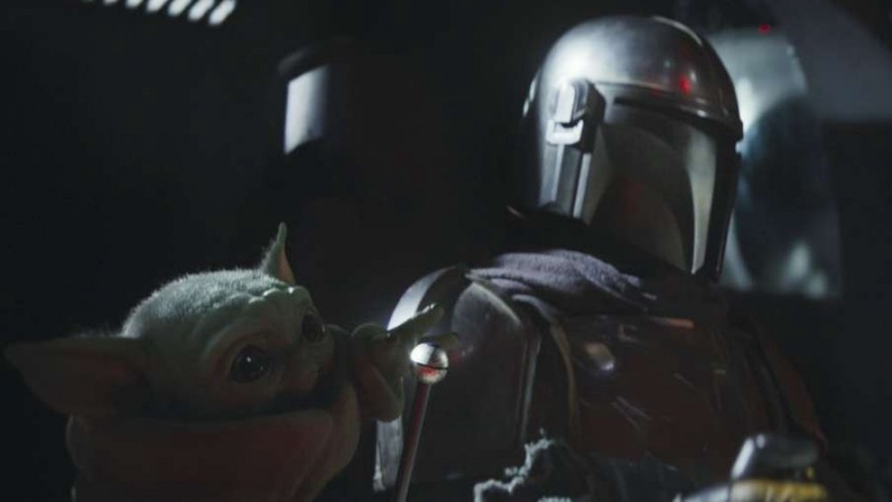 Pedro Pascal as Din Djarin and the Child in The Mandalorian