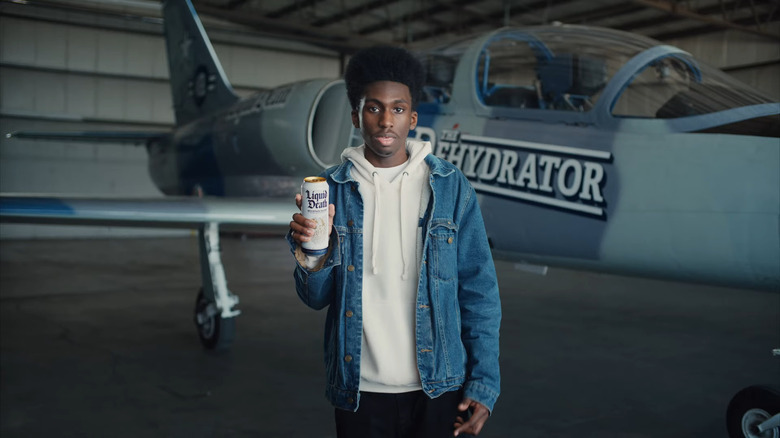 Man holding Liquid Death can