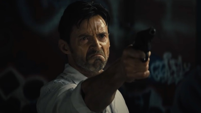 Nick Bannister (Hugh Jackman) holding gun in Reminiscence