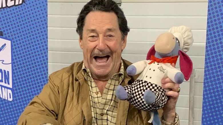 Peter Cullen holding Eeyore doll