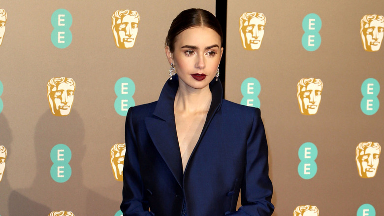 Lily Collins with a blue jacket dress