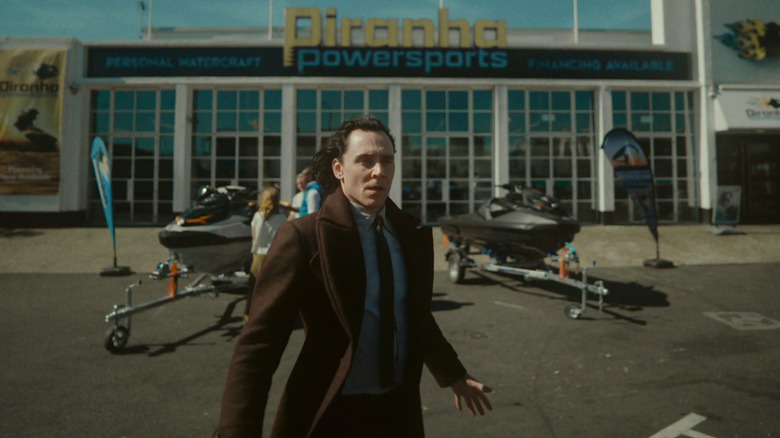 Loki stands near two jet skis