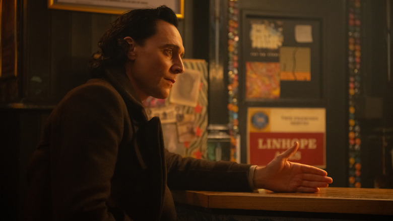 Loki sitting at a bar