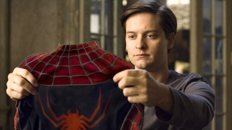 Peter Parker looks at his Spider-Man suit