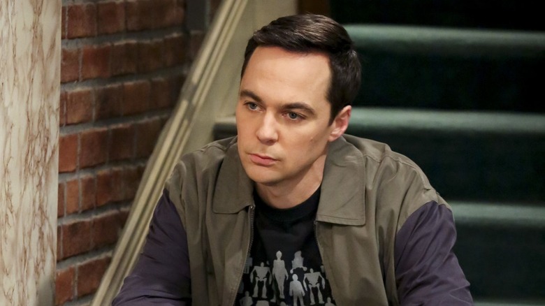 Sheldon sitting on stairs frowning jacket graphic tee