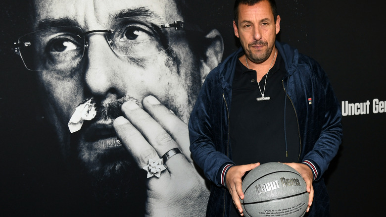 Adam Sandler holds basketball