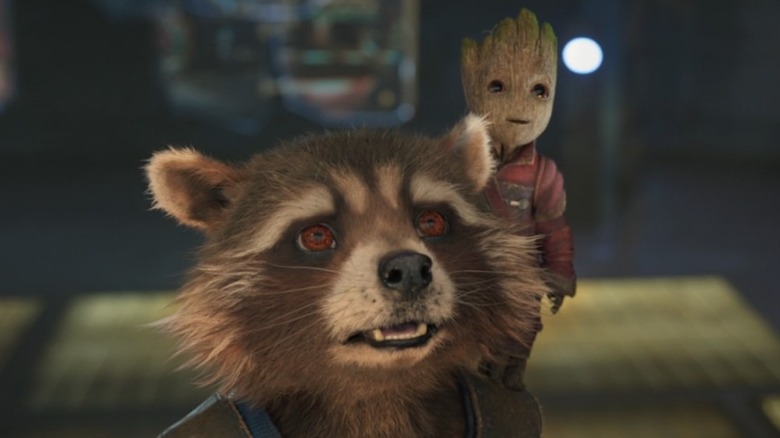 Baby Groot rests on Rocket's shoulder