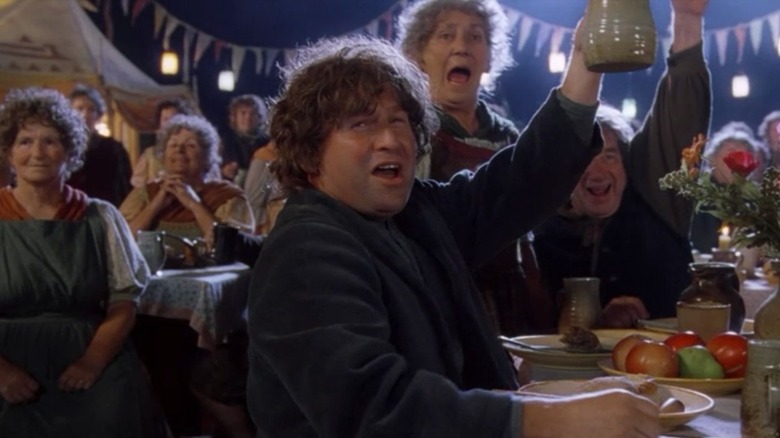 Hobbits cheer at Bilbo's party