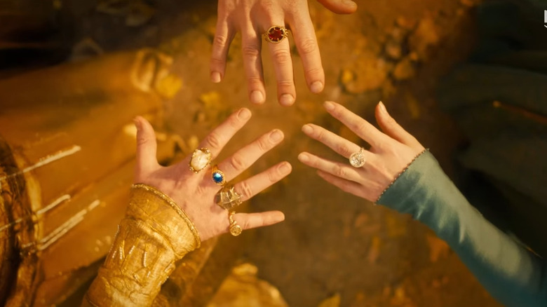 Three hands with rings