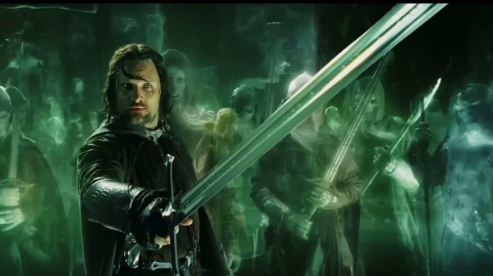 Viggo Mortensen as Aragorn carrying Andúril in The Lord of the Rings