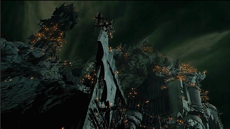 The tower of Barad-dûr lit with torches