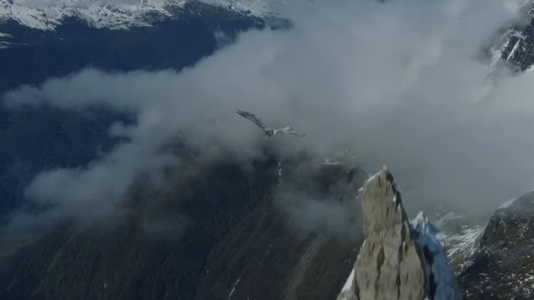 Distant Eagle flies over mountain