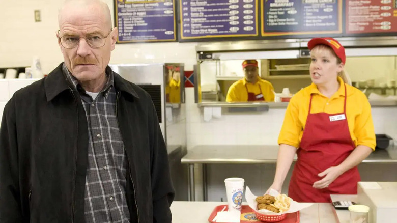 Walt standing at the counter next to an employee