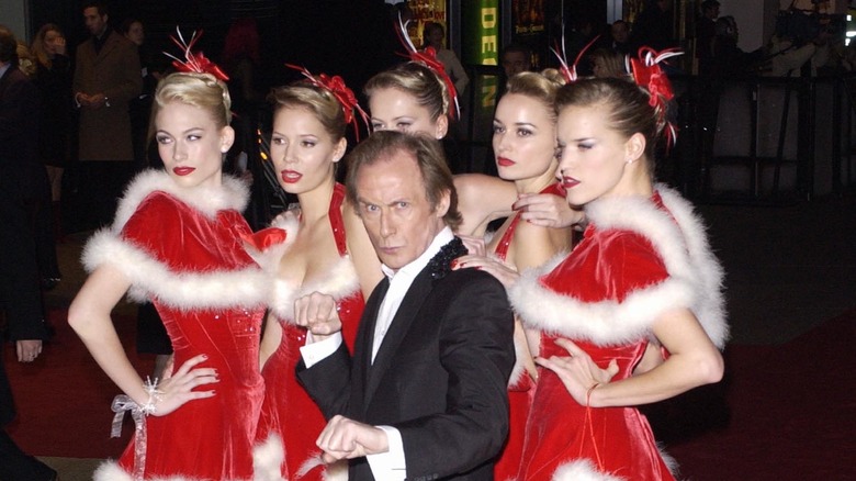 Bill Nighy posing with women