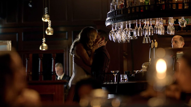 Charlotte and Dan kissing in a bar