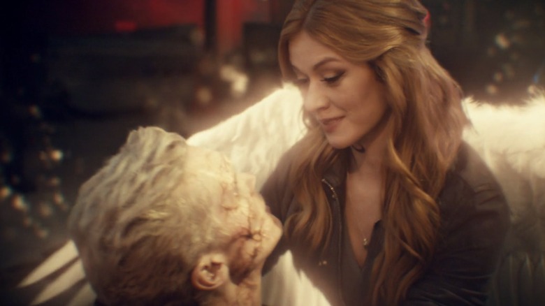 Clary with angel wings holding Jonathan