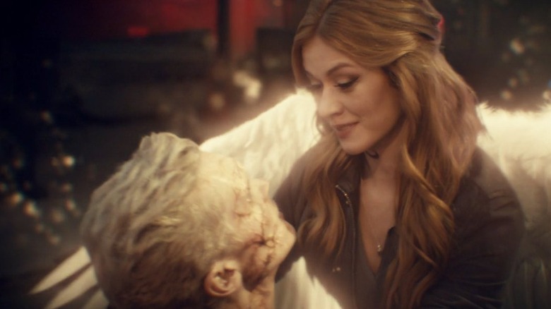 Clary with angel wings holding Jonathan