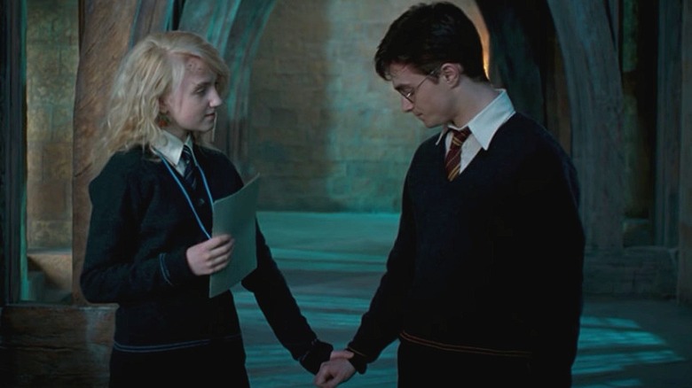 Luna Lovegood holding Harry Potter's hand