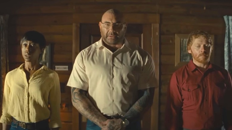 Nikki Amuka-Bird, Dave Bautista, and Rupert Grint looking menacing in Knock at the Cabin