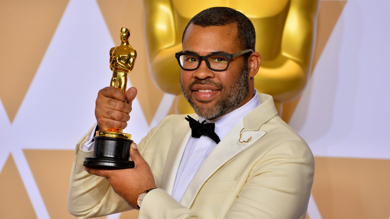 Jordan Peele holding Oscar