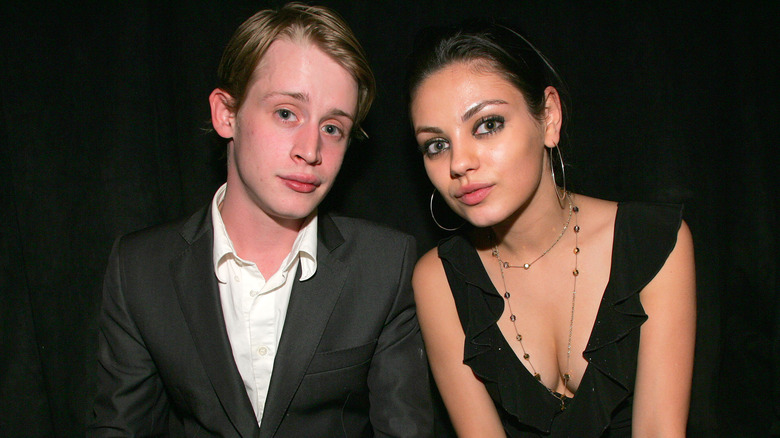 Macaulay Culkin and Mila Kunis posing