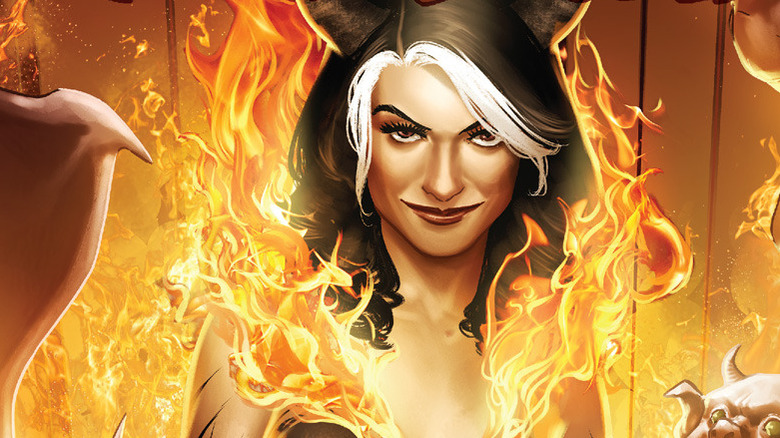 Madam Satan standing in fire.