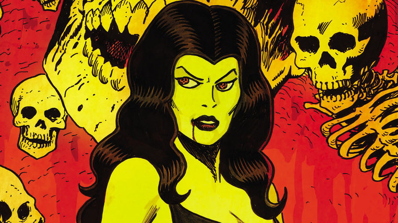 Madam Satan standing in front of skulls