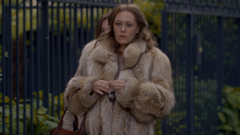 Madame Claude wearing fur coat