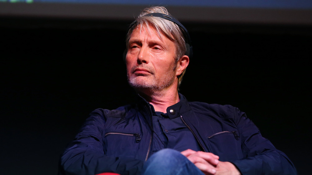 Mads Mikkelsen wearing a blue jacket