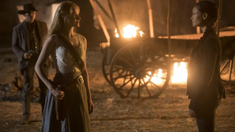 Maeve and Dolores talk next to burning carriage