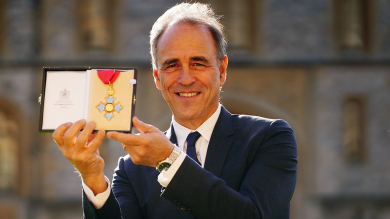 Anthony Horowitz smiling with medal