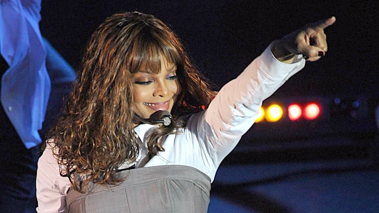 Janet Jackson pointing toward her audience