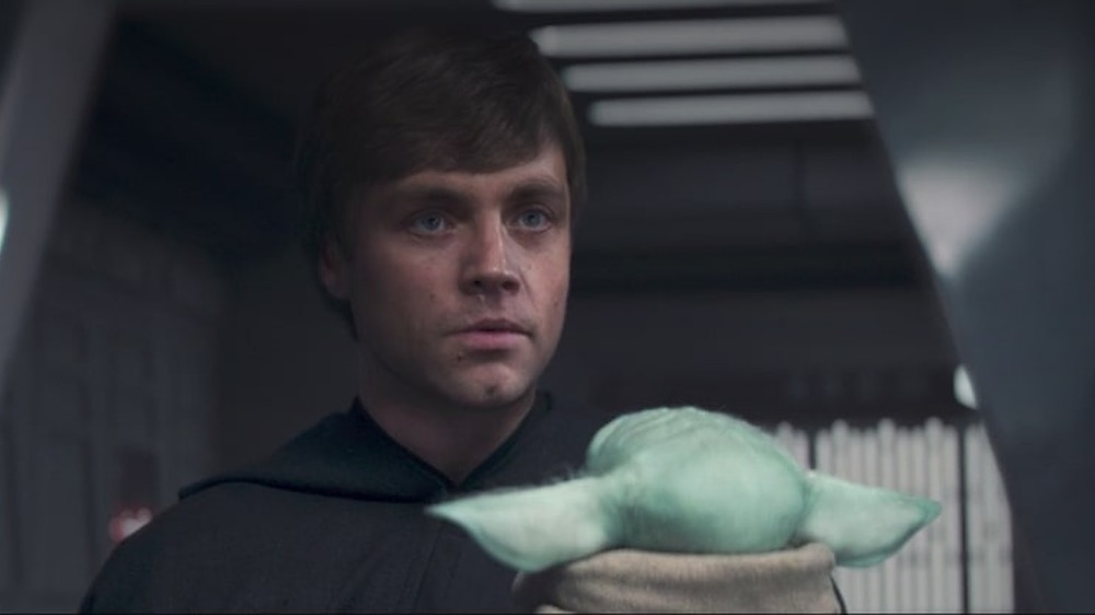 De-aged Luke holding Grogu