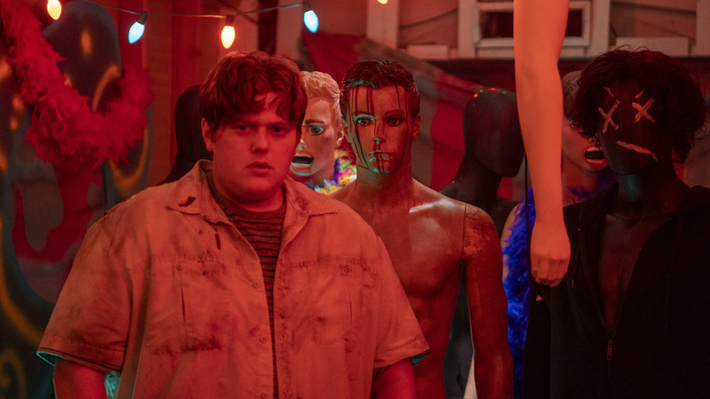 Ryan surrounded by bloody mannequins in 'Unhuman' still