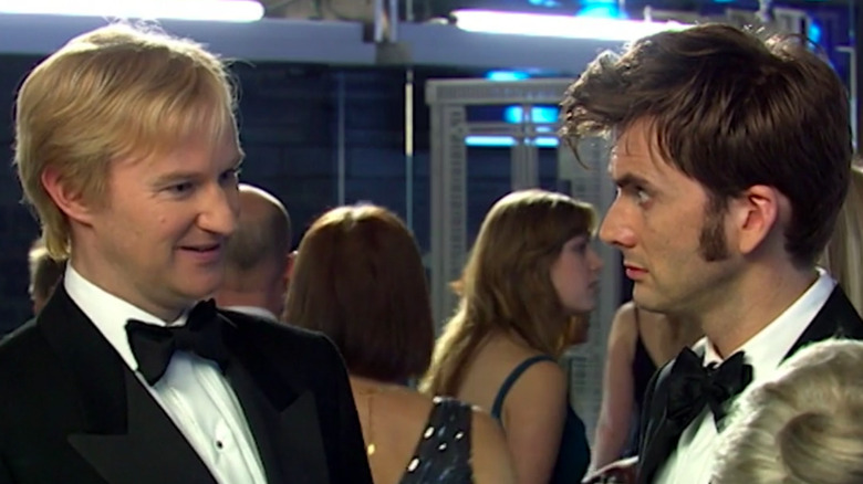 A smiling Mark Gatiss in an episode of Doctor Who with David Tennant as the Doctor