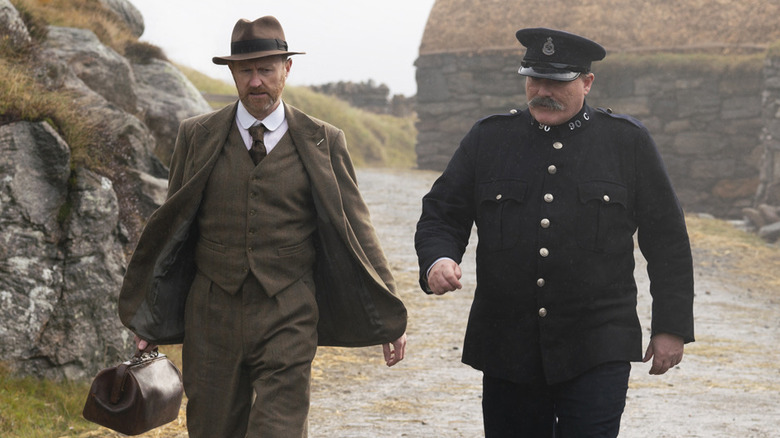 Doctor Maclean walking with Constable McRae in The Road Dance