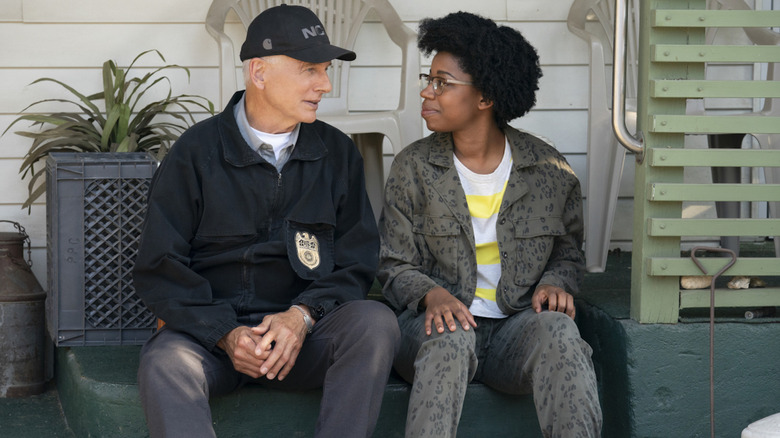 Mark Harmon as Agent Gibbs and Diona Reasonover as Kasie Hines sitting on steps in NCIS 
