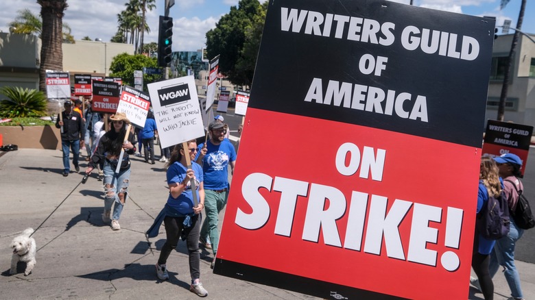 The writers guild marching a picket on a street