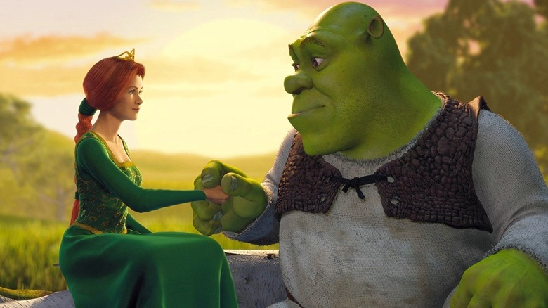Shrek holds Fiona's hand