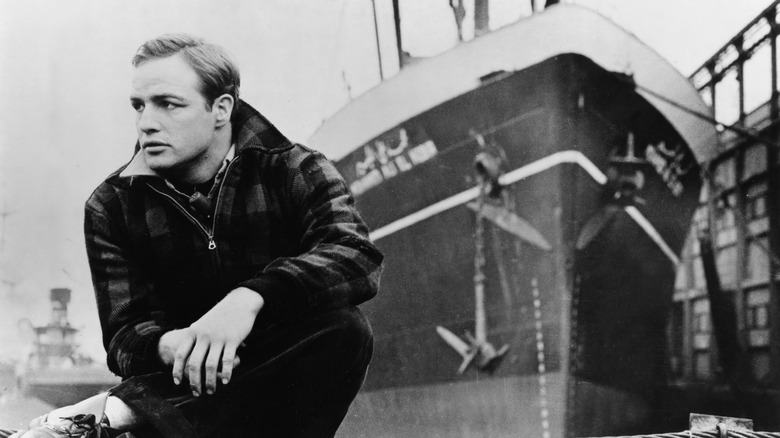 Marlon Brando sits on a dock