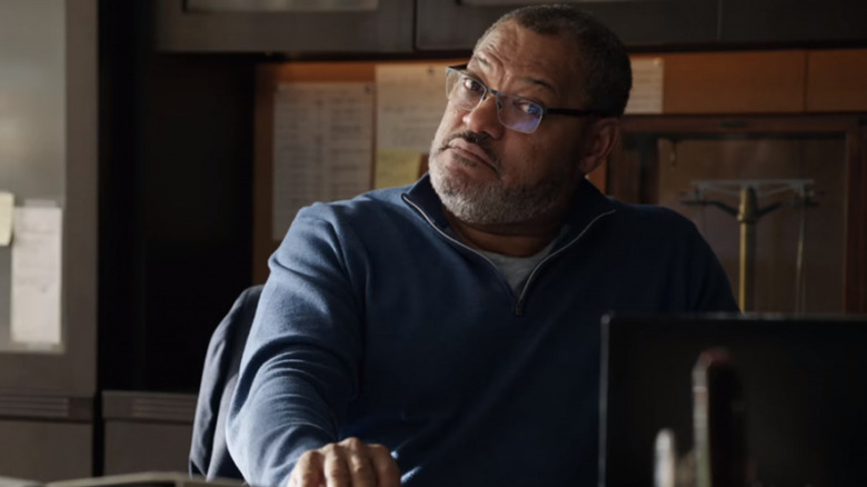 Dr. Bill Foster sitting at desk wearing glasses