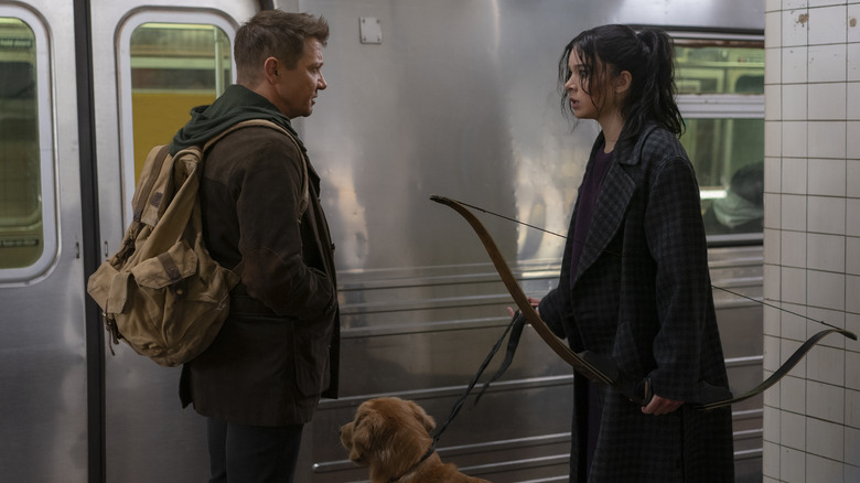 Clint, Kate, and Lucky next to subway car