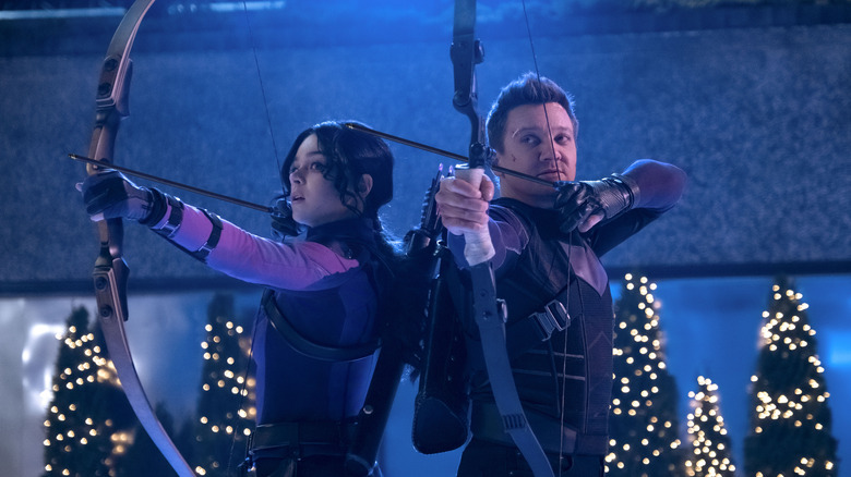 Kate and Clint using bows