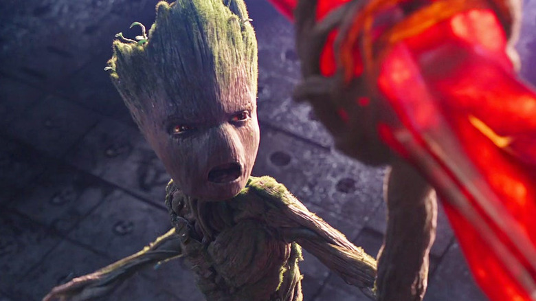 Groot holds up stone