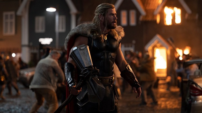 Thor walking through burning town with axe