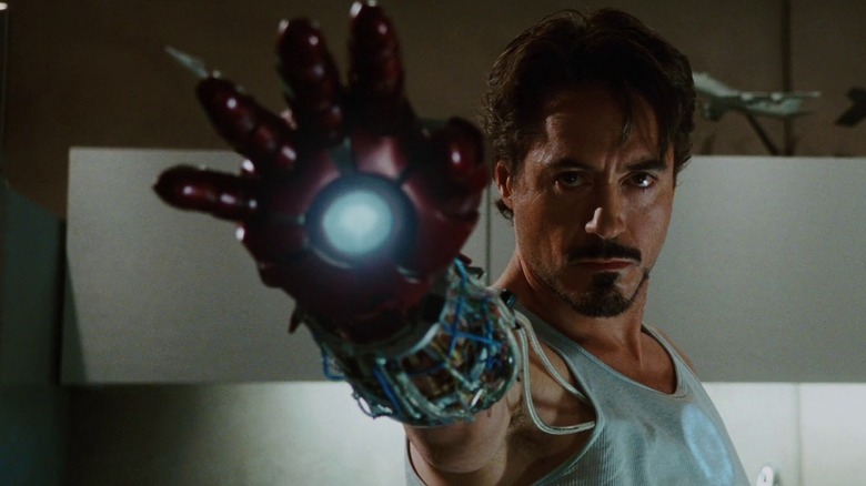 Tony Stark raises his iron hand in "Iron Man" (2008)